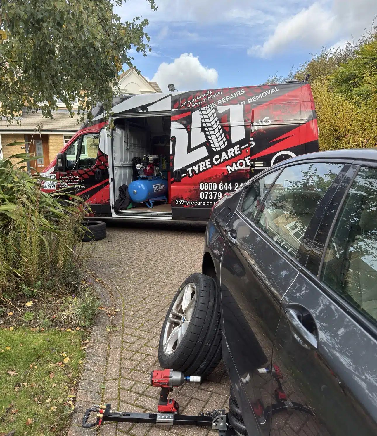 247 Tyre Care technician fitting a tyre on a customer's driveway